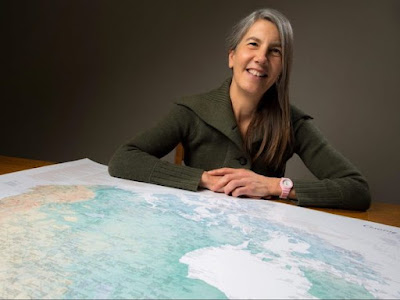 Margaret Pearce in front of a map